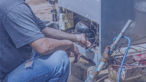 man-fridge-small Technician working on the motor and wiring assembly of an industrial cooling unit.